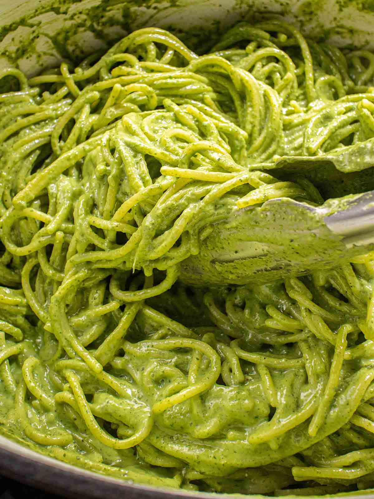 green sauce pasta mixing