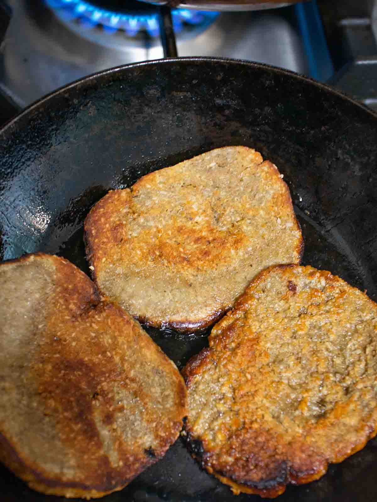 sliced.vegan roast fried in a pan