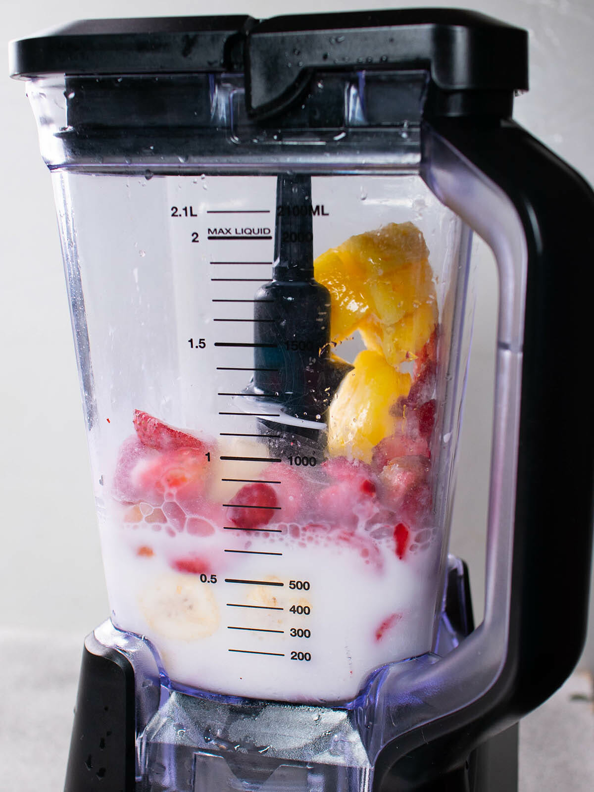 place frozen fruits in the blender
