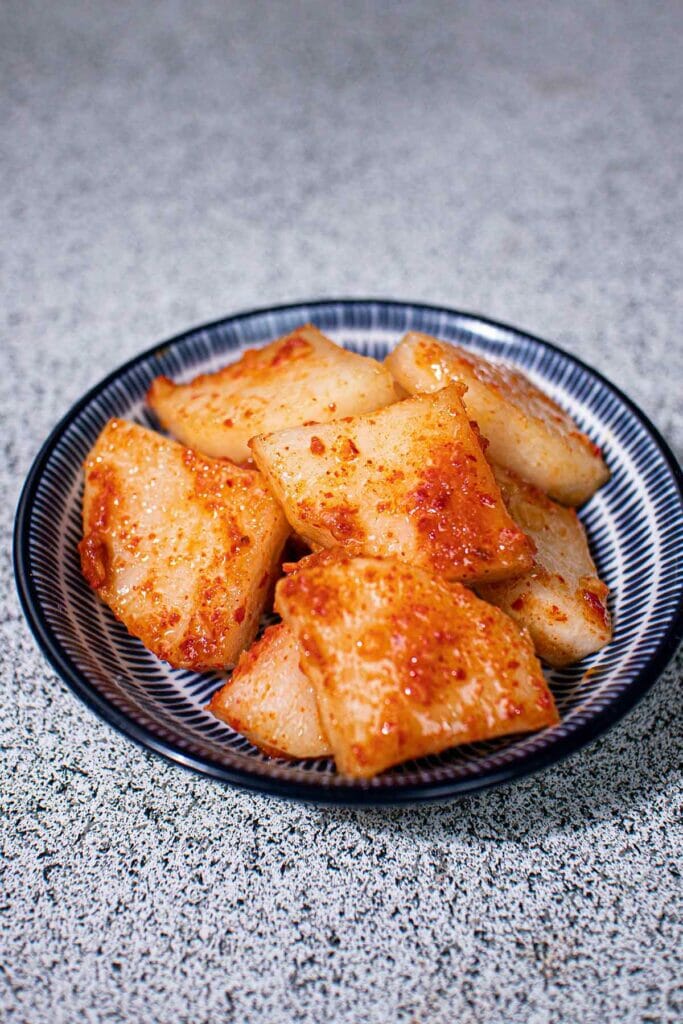 a plate of pickled daikon slices