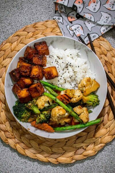 a dish with rice, veggies and tofu