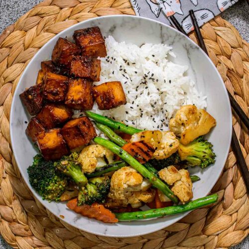 a dish with rice, veggies and tofu