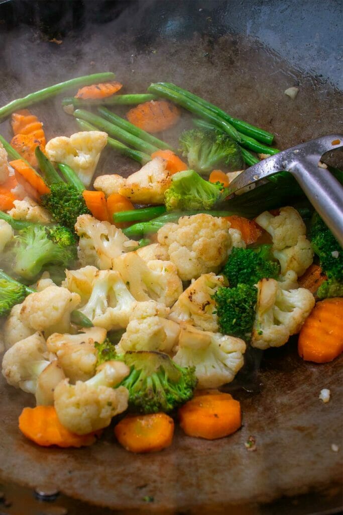 charred veggies in a hot wok