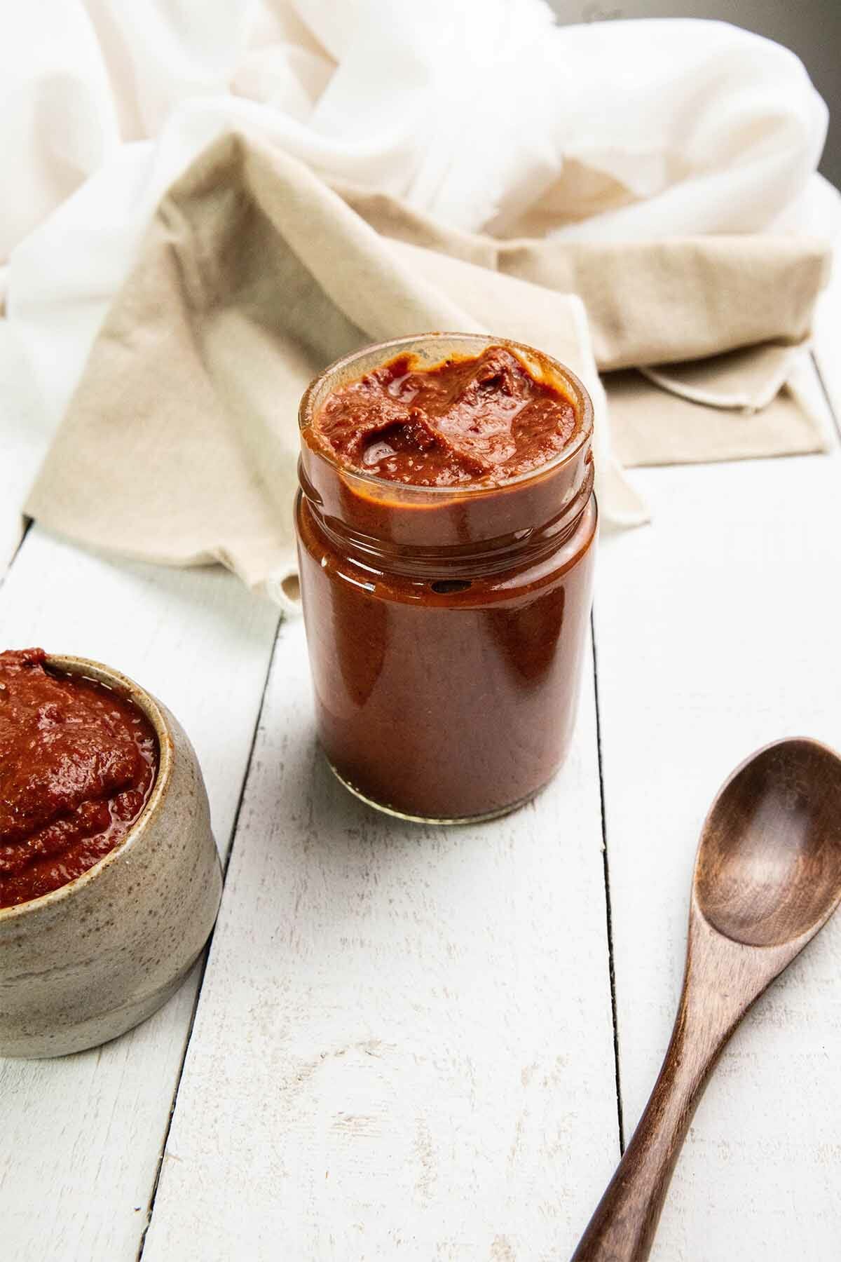 a glass jar of red sauce